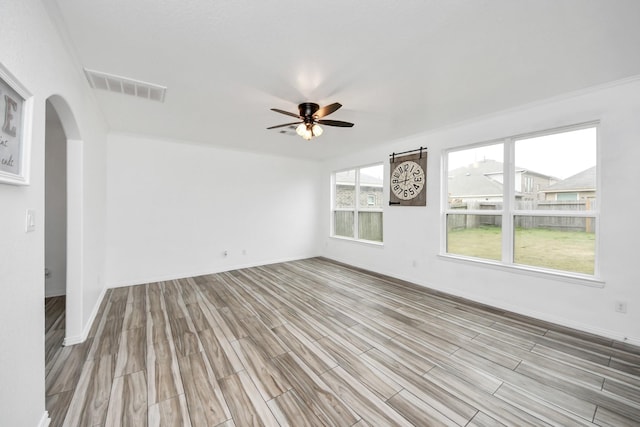 empty room featuring light wood-type flooring and ceiling fan