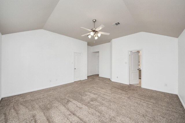 unfurnished bedroom with ceiling fan, carpet, and lofted ceiling