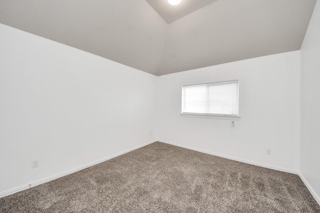 unfurnished room with carpet floors and lofted ceiling