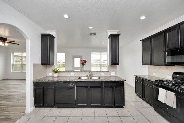 kitchen featuring black appliances, light stone countertops, sink, ornamental molding, and ceiling fan