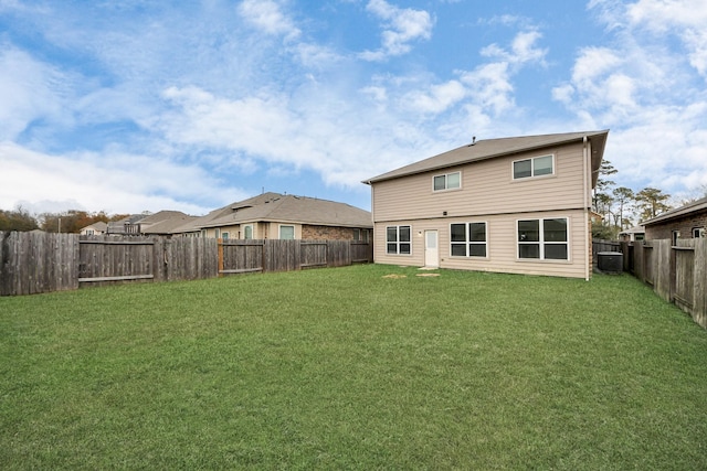 back of property featuring a lawn and central AC