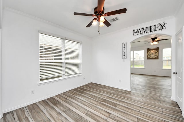 empty room with ceiling fan and ornamental molding