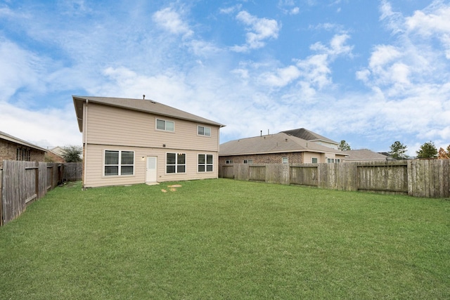 back of house featuring a yard