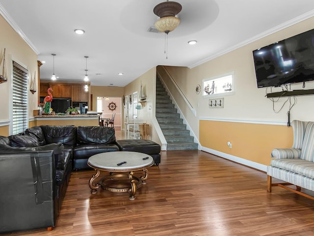 living room featuring ceiling fan, wood-type flooring, and crown molding