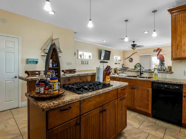 kitchen with decorative light fixtures, sink, a center island, and black appliances