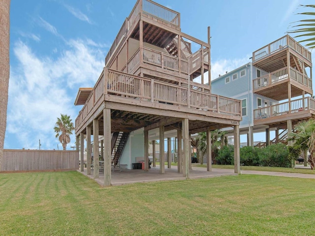 view of property's community featuring a wooden deck, a yard, and a patio