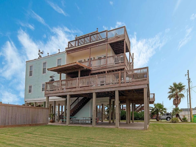 back of house featuring a lawn and a patio area