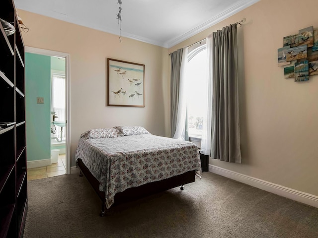 bedroom with ornamental molding and carpet flooring