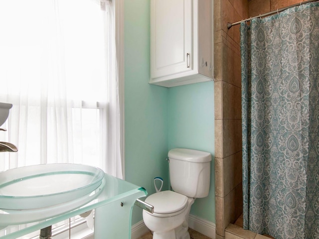 bathroom featuring toilet and a shower with curtain