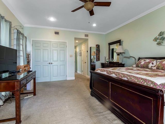 carpeted bedroom with ceiling fan, ornamental molding, and a closet