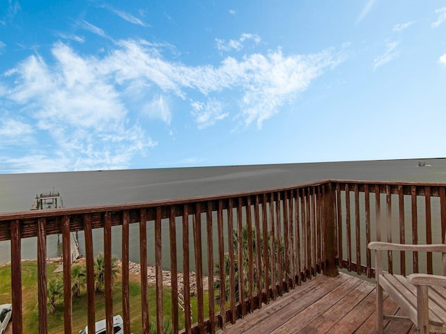 wooden terrace featuring a water view