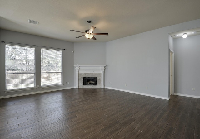 unfurnished living room with ceiling fan and a tile fireplace