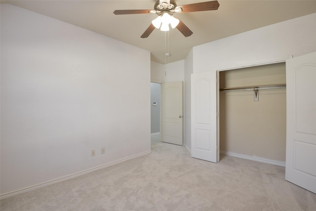 unfurnished bedroom featuring ceiling fan, a closet, and light carpet