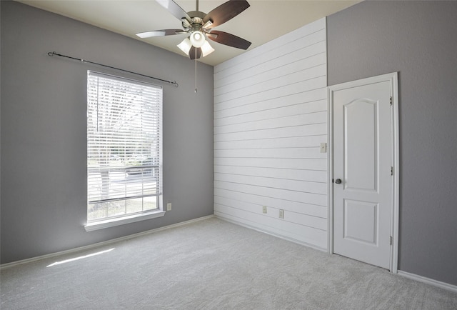 empty room with ceiling fan and light colored carpet