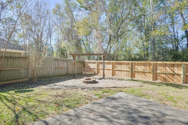 view of yard with a fire pit and a patio