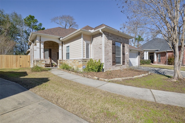 view of front of home featuring a front yard and a garage