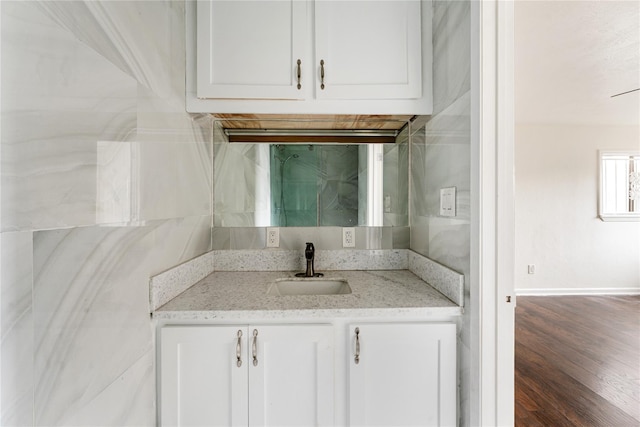 bathroom with hardwood / wood-style flooring and vanity