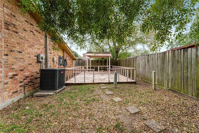 view of yard featuring central AC, a gazebo, and a deck