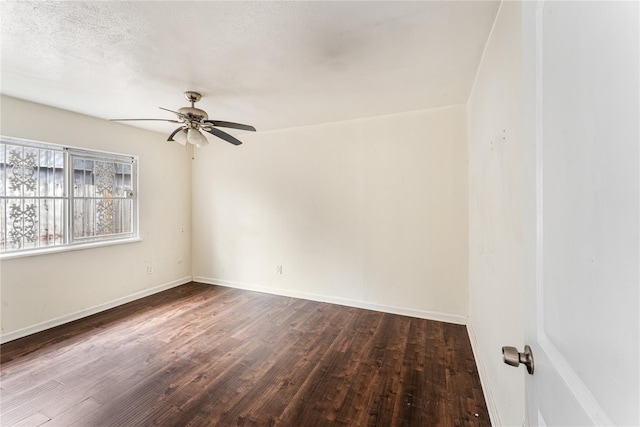 unfurnished room with a textured ceiling, dark wood-type flooring, and ceiling fan