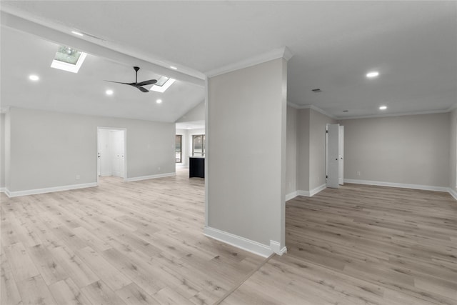 unfurnished living room featuring ceiling fan, lofted ceiling with skylight, ornamental molding, and light hardwood / wood-style floors