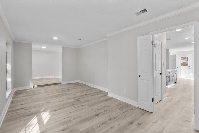 unfurnished room featuring crown molding and light hardwood / wood-style flooring