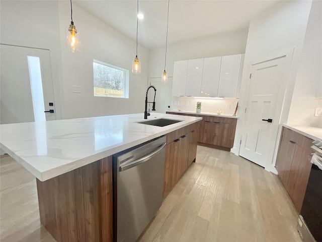 kitchen with white cabinetry, appliances with stainless steel finishes, backsplash, decorative light fixtures, and sink