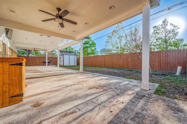 view of patio featuring ceiling fan and a storage shed