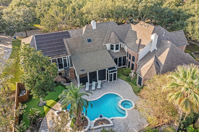 view of swimming pool featuring a patio area and a sunroom