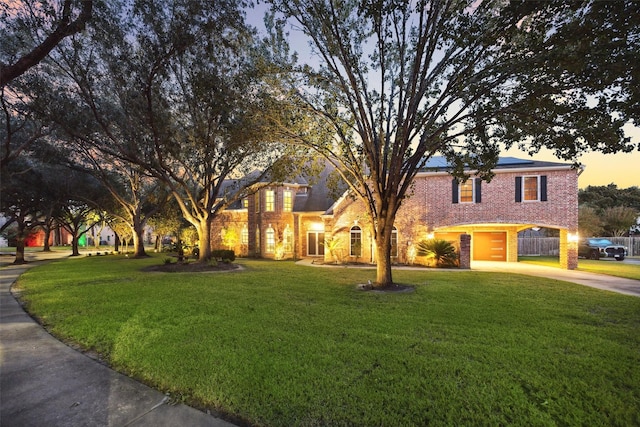 view of front of house featuring a garage and a yard