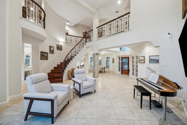 living room with french doors and a high ceiling