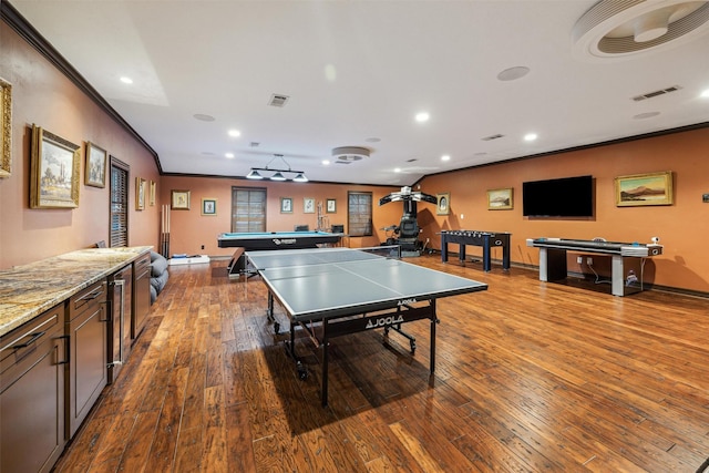 recreation room with hardwood / wood-style flooring, crown molding, and billiards