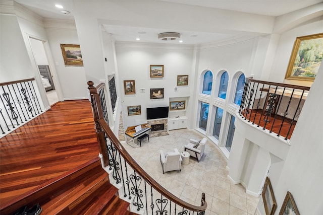 staircase with hardwood / wood-style flooring and ornamental molding