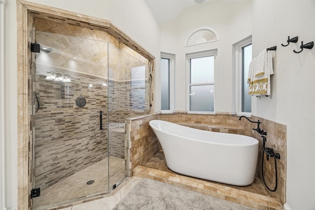 bathroom featuring lofted ceiling and shower with separate bathtub