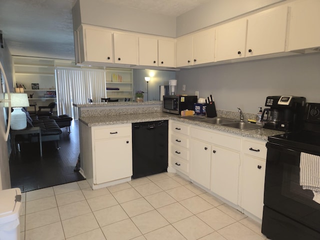 kitchen with sink, white cabinets, and black appliances