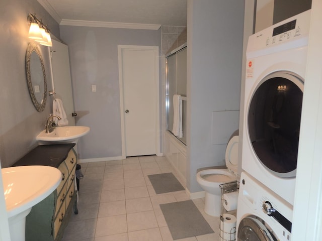 full bathroom with shower / bath combination with glass door, tile patterned flooring, stacked washer / drying machine, toilet, and ornamental molding