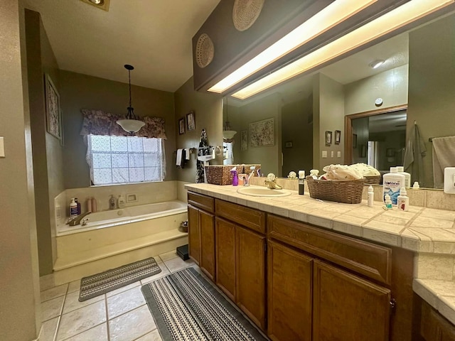 bathroom featuring tile patterned floors, vanity, and a tub to relax in