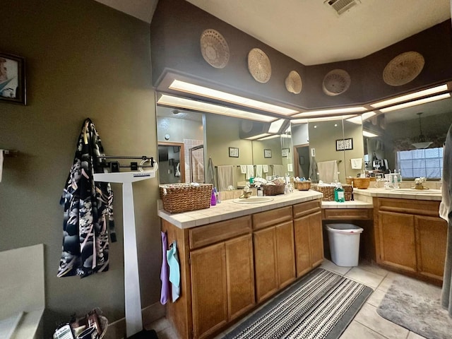 bathroom featuring walk in shower, vanity, and tile patterned flooring