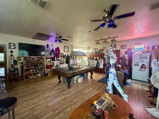 recreation room featuring ceiling fan, wood-type flooring, pool table, and a textured ceiling