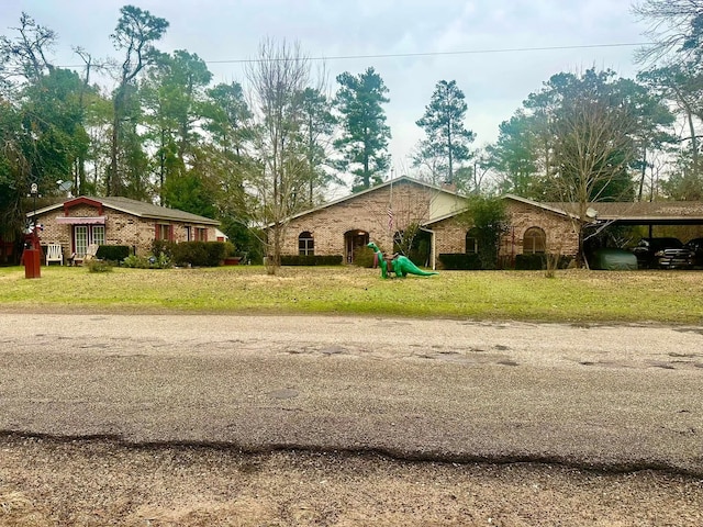 view of home's exterior featuring a yard and a carport