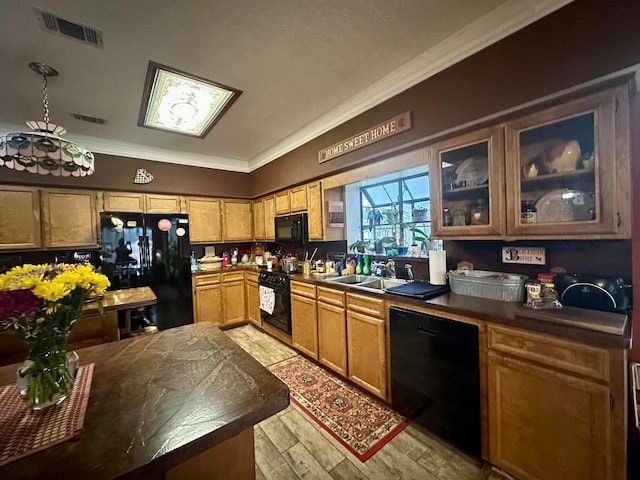 kitchen featuring ornamental molding, sink, light hardwood / wood-style flooring, and black appliances