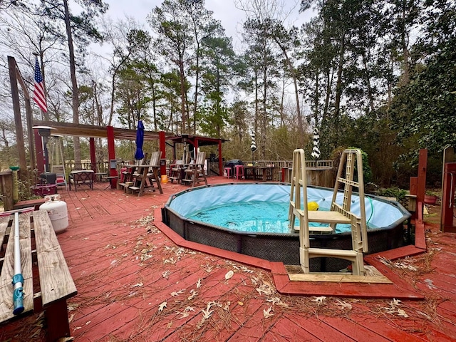 view of swimming pool featuring a wooden deck