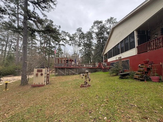 view of yard with a wooden deck and a sunroom