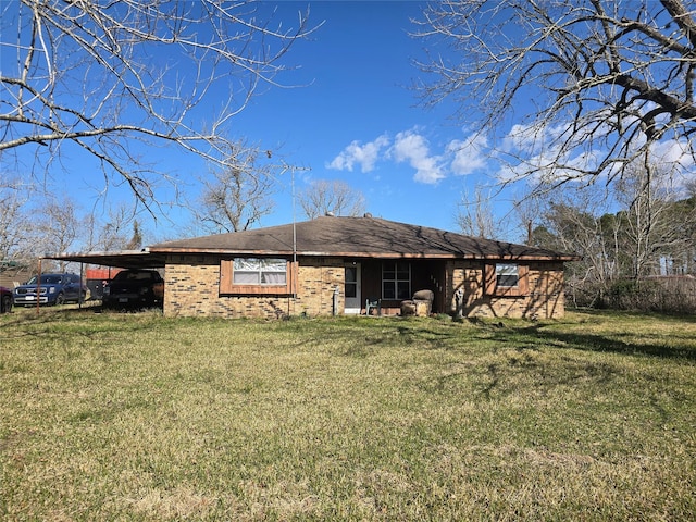 exterior space featuring a carport and a lawn