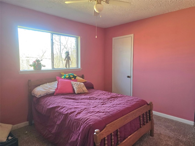 bedroom with ceiling fan, a textured ceiling, and carpet flooring