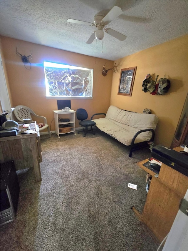 interior space featuring ceiling fan, a textured ceiling, and dark colored carpet