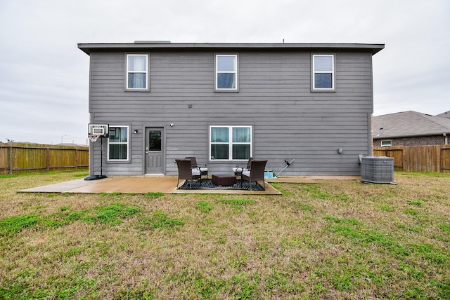 back of property with central air condition unit, an outdoor living space, a patio area, and a yard