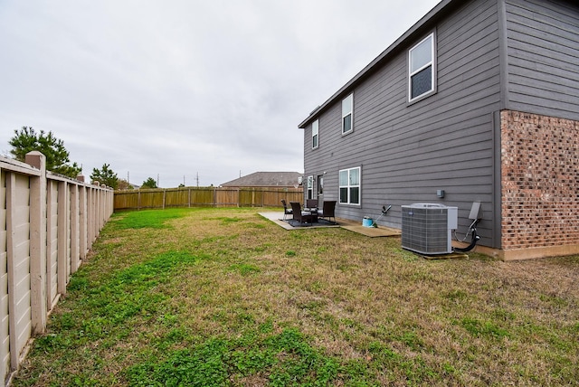 view of yard with central AC unit and a patio area