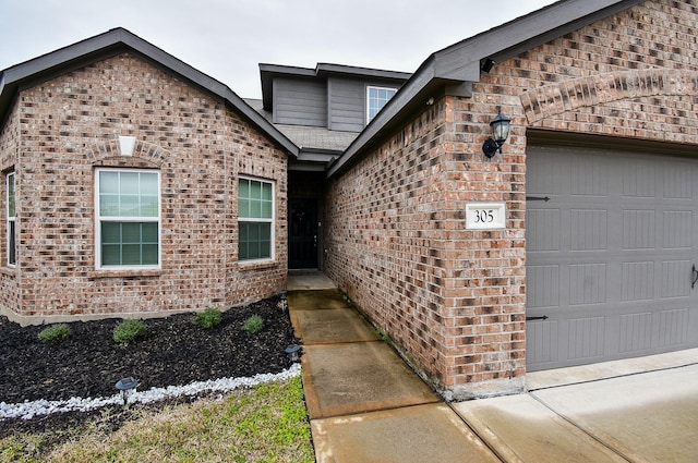 view of exterior entry featuring a garage