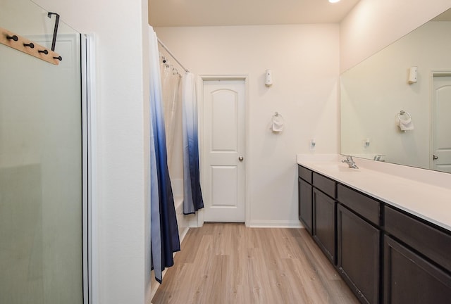 bathroom featuring a shower with curtain, hardwood / wood-style floors, and vanity