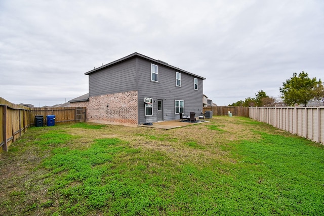 back of house featuring a patio area and a yard